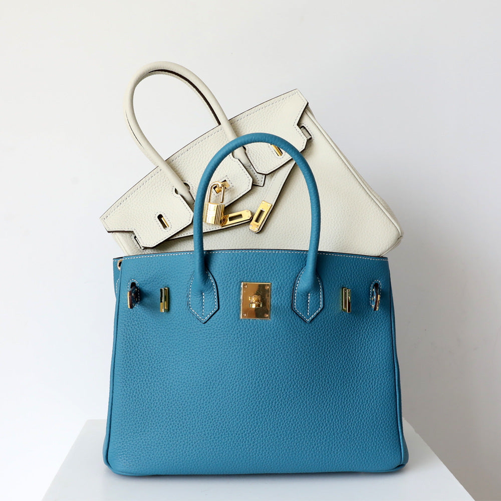 Women's Leather Handbag with Multiple Pockets and Twist Lock Closure